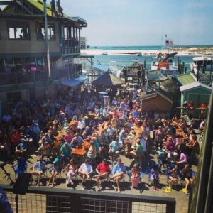 Live band playing on the harborfront stage at AJ’s Oyster Bar in Destin Florida