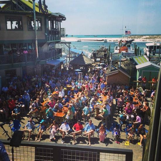 Live band playing on the harborfront stage at AJ’s Oyster Bar in Destin Florida