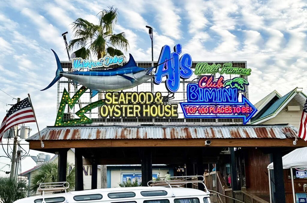 Outdoor crowd enjoying happy hour at AJ’s Seafood and Oyster Bar in Destin Florida