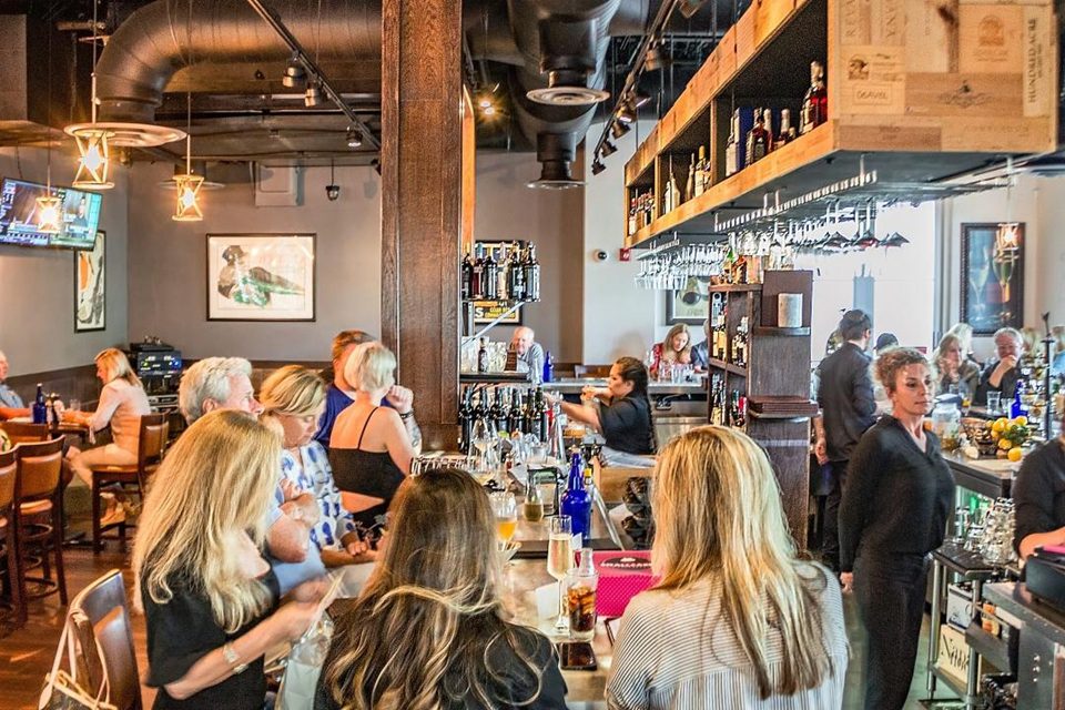 Guests enjoying happy hour at Cuvee 30A bar area in Inlet Beach