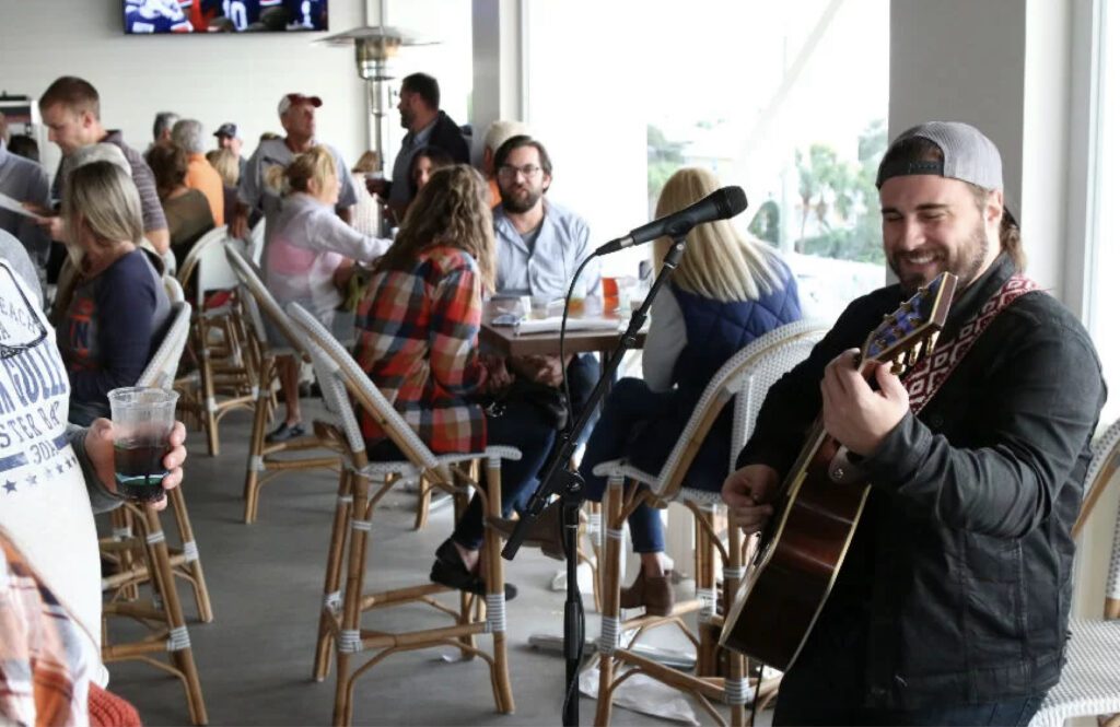 Musician performing on outdoor patio at Shunk Gulley Oyster Bar in Santa Rosa Beach FL